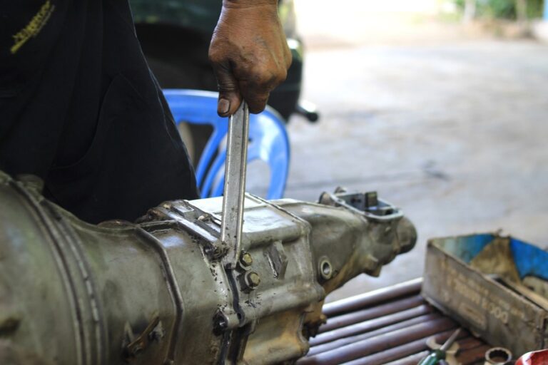 Technician working on an automotive transmission, illustrating car transmission slipping repair and diagnostics in Glendora, CA.